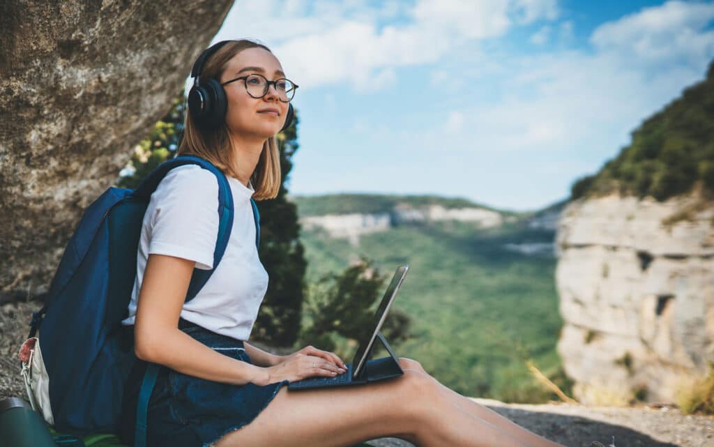 happy young girl tourist with backpack enjoying summer holidays