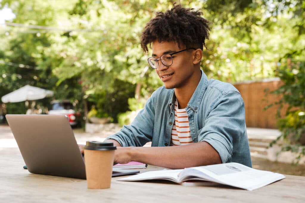 Smiling young african man student studying