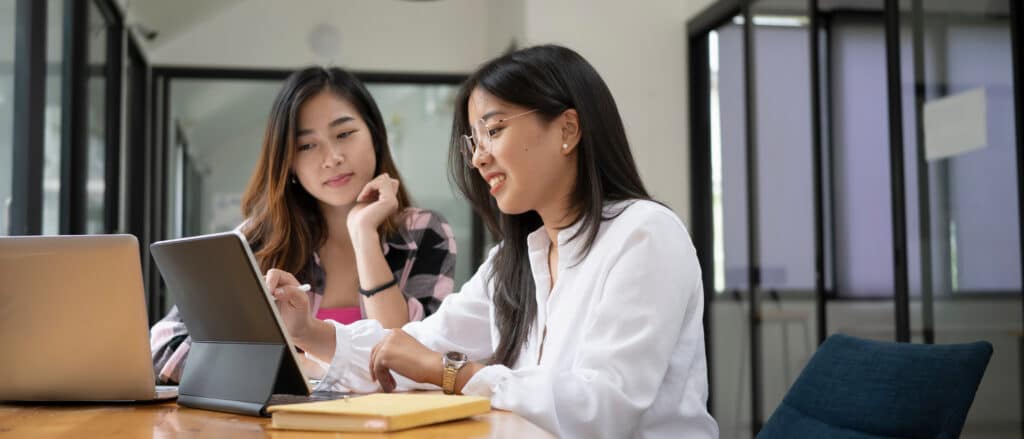 Two women working in front of a laptop