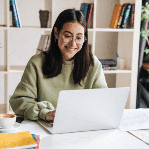 woman smiling at laptop while learning